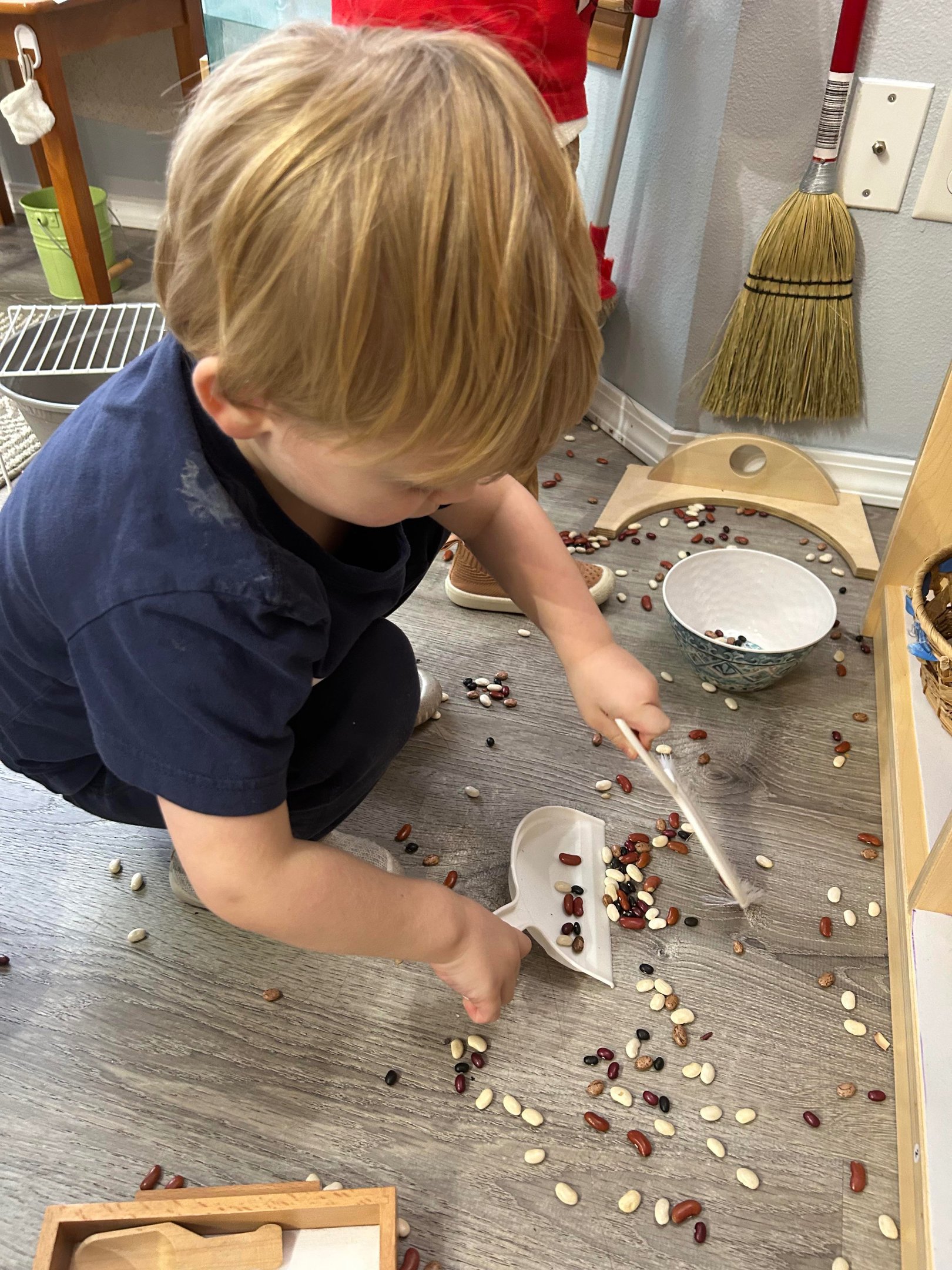 Child practicing a practical life activity