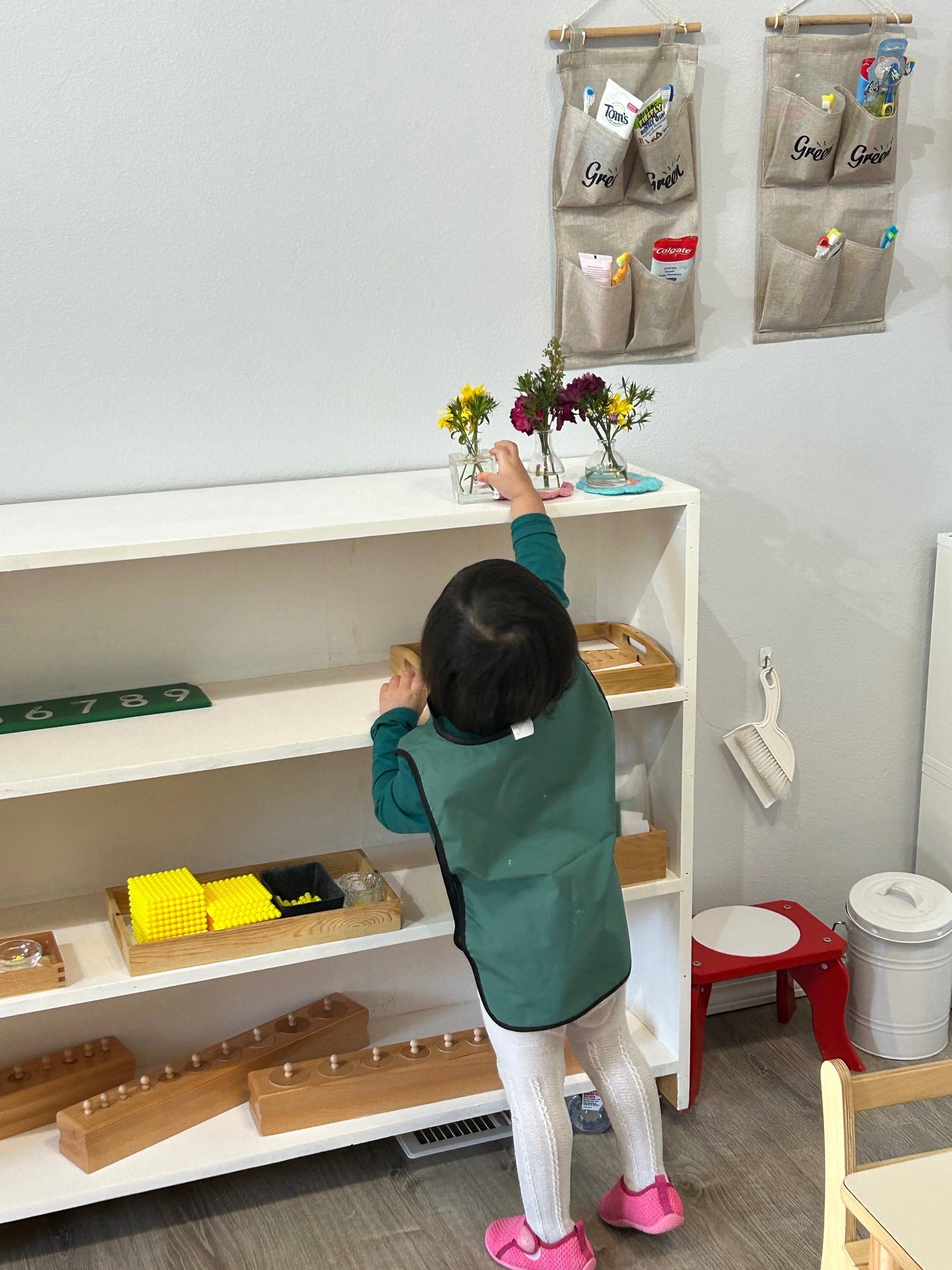 Child arranging flowers in a Montessori classroom