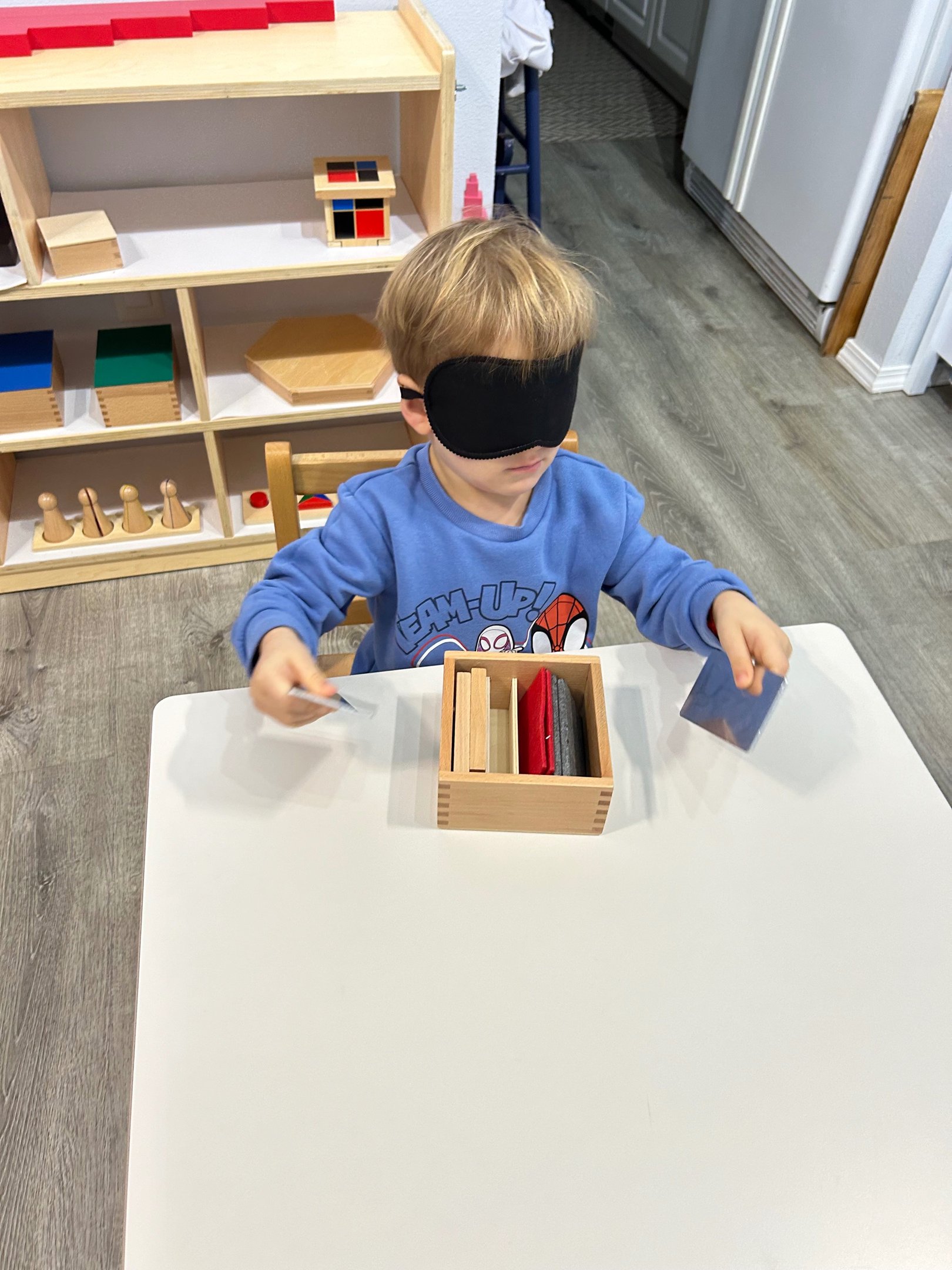 Child exploring Montessori sensorial materials